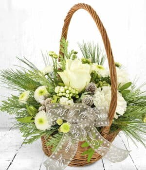 Snow Ball Flower Basket Basket Arrangement Featuring Red Roses, Carnations, Hypericum Berries, Chrysanthemums, And Festive Greenery Topped With A Bow.