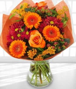 Shepherd’s Delight Flower Bouquet featuring orange roses, orange germini, red chrysanthemums and hypericum berries arranged beautifully for a bold, joyful display