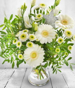 Frosty Morning Flower Bouquet Hand-tied bouquet featuring white Germini, Chrysanthemums, Lisianthus and a silver star pick, creating a frosty, festive look.
