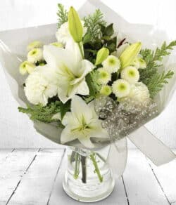 Cool Christmas Flower Bouquet Hand-tied bouquet featuring white lilies, carnations, and chrysanthemums with green foliage, finished with a festive bow.