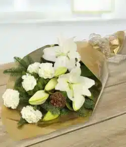 Elegance Flower Bouquet Flat bouquet featuring white lilies and carnations accented by green foliage, finished with a festive bow.