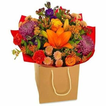 Equinox Flower Bouquet A Hand-Tied Autumn Bouquet Displayed In A Gift Bag, Featuring Orange Lilies, Purple Blooms, Roses, Lisianthus, Chrysanthemums, And Rich Foliage.