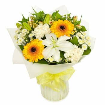 Sunshine Flower Bouquet Featuring White Lilies, Yellow Germini, White Carnations, Alstroemeria, And Chrysanthemums, Wrapped In Cellophane With A Bow.
