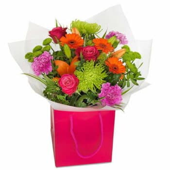 Fruit Salad Flower Bouquet Featuring Orange Lilies, Orange Germini, Cerise Roses, And Green Blooms In A Hollywood Cerise Gift Bag.