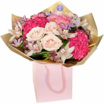Majestic Flower Bouquet A Luxurious Hand-Tied Bouquet In Pink Tones Featuring Roses, Hydrangea, Germini, And Orchids, Wrapped In Gold Cellophane And A Pink Gift Bag.