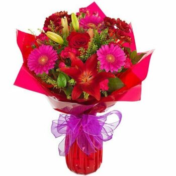 Romantic Bouquet A Hand-Tied Bouquet Featuring Deep Red Carnations, Elegant Lilies, Vibrant Germini, And Lush Seasonal Foliage For A Romantic Display.