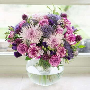 Countryside Flower Bouquet Featuring Pink Roses, Purple And Lilac Blooms, Long-Lasting Carnations, And Fragrant Eucalyptus In A Rustic Design.