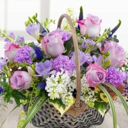 Fabulously Fragrant Flower Basket Featuring Lilac Roses, Carnations, White Lilacs, Lavender Stocks, Freesias, And Purple Veronica In A Charming Basket