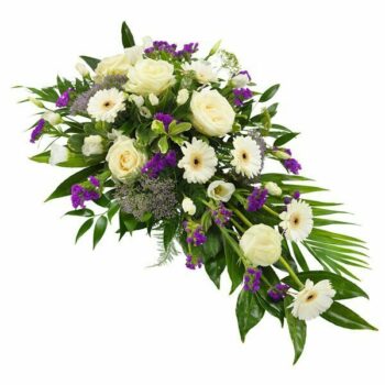 Purple And White Spray Featuring White Gerberas, White Roses, And Purple Blooms Arranged On A Bed Of Greenery As A Funeral Tribute.