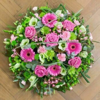 Reflection Posy Arrangement – Pink Roses, Spray Carnations, Germini, Green Lisianthus, Lush Foliage, And China Grass Loops For A Unique, Elegant Finish.