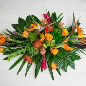 Tropical Touch Spray Arrangement Featuring Lime-Green Cymbidium Orchids, Hot Orange Roses, Red Ginger Flowers, And Lush Tropical Foliage.