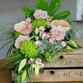 Life’s A Peach Sheaf Arrangement Featuring Pale Pink Dusky Roses, Lime Green Shamrock Blooms, And Fragrant Eucalyptus Foliage In A Hand-Tied Design.