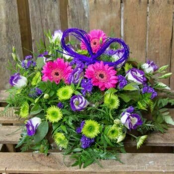 Touch Of Purple Posy Arrangement Loose Posy Featuring Pink Germini, Purple-Tipped Lisianthus, Eucalyptus, And Leather Leaf In A Stylish, Rounded Arrangement.