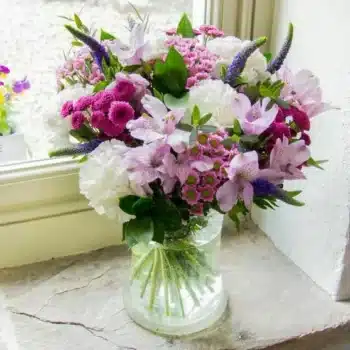 Simply Cherished Flower Bouquet Featuring Purple Alstroemeria, Veronica, White Carnations, Deep Pink Santini, And Eucalyptus Arranged In A Lush, Elegant Design.