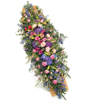 Pink And Mauve Coffin Spray Featuring Roses, Hydrangeas, Lilies, And Carnations With Lush Green Foliage Arranged In A Graceful Display.