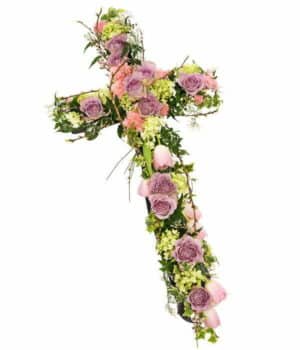 Pink Cross Funeral Tribute Featuring Lavender And Pink Roses, Hydrangea, Jasmine, Tulips, Genista, And Carnations In A Graceful Design.