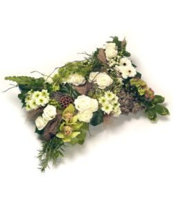 Green and White Pillow Tribute pillow-shaped floral tribute featuring roses, Cymbidium orchids, chrysanthemums, hydrangea, and rich green foliage.