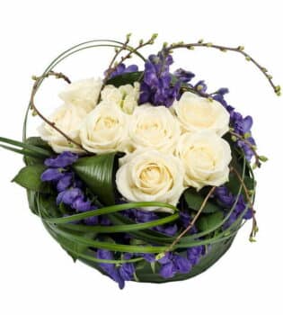 Purple And White Flower Posy Purple And White Posy Pad Featuring Cream Roses And Purple Aconitum, Accented With Aspidistra Leaves And Lily Grass Foliage In A Neat Design.
