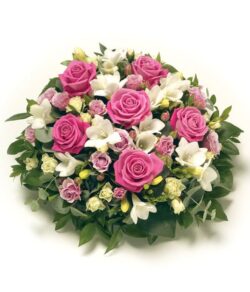 Pink and White Flower Posy Pink and white flower posy featuring pink Roses, white Roses, and white Freesias arranged in a round pad with soft greenery.