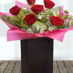 Be Mine Flower Bouquet Featuring Six High-Quality Red Roses Arranged In An Aqua Pack Gift Bag For A Passionate And Elegant Floral Gift.