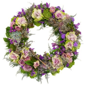 Purple And Lilac Wreath Tribute Circular Funeral Wreath Featuring Purple And Lilac Flowers With Lush Greenery, Arranged In A Graceful And Elegant Design.