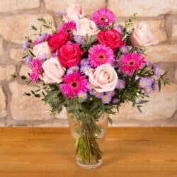 Gorgeous Flower Bouquet featuring pale pink roses and striking purple September flowers in a creative blend of hot pink and muted tones for an elegant gift.
