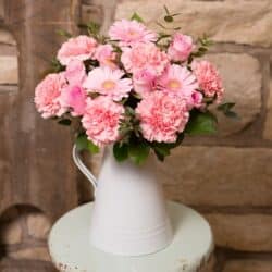 Raspberry Rush Floral Bouquet featuring pink roses, pink germini and carnations in a hand-tied arrangement for an elegant and long-lasting gift.