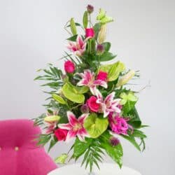 Sweet Tropic Flower Bouquet featuring hot pink roses, fragrant lilies, and lime-green anthuriums in a vibrant, tropical arrangement.