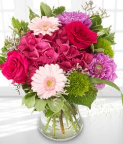 Afternoon Delight Flower Bouquet featuring cerise hydrangea, pink germini, cerise roses and dahlia, hand-tied with mixed foliage for a vibrant display.